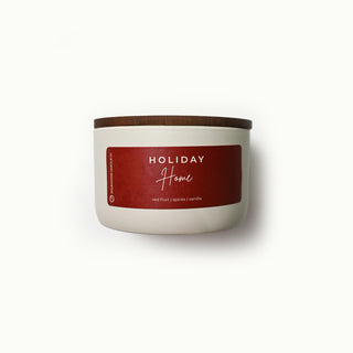 10 oz statement candle with a red 'Holiday Home' label on a white background