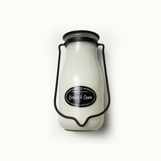 14 oz white milk bottle candle with a black lid and 'Berries & Cream' label on a white background