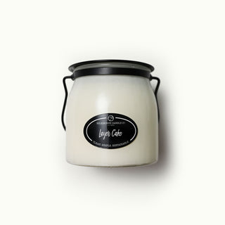 16 oz white candle jar with black lid and 'Layer Cake' label on a white background