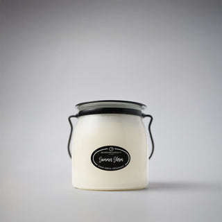 16 oz white candle in a glass jar with a black lid and 'Summer Storm' label on a white background