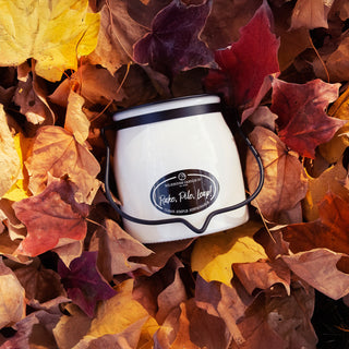 16 oz white candle with black rim and decorative 'Rake, Pile, Leap!' label surrounded by autumn leaves