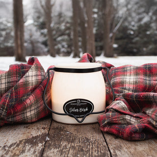 16 oz candle labeled 'Silver Birch' with a plaid blanket and snowy forest background