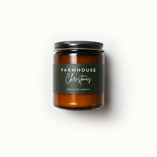 The Classic Collection amber jar candle with a 'Farmhouse Christmas' label on a white background