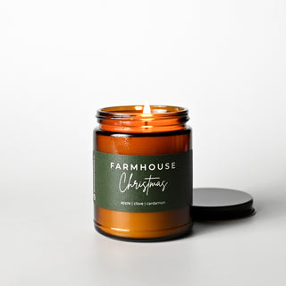 The Classic Collection candle in an amber jar with a 'Farmhouse Christmas' label on a white background