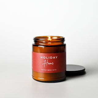 The Classic Collection candle in an amber jar with a 'Holiday Home' label on a white background