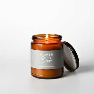 The Classic Collection candle in an amber jar with a 'Silver Birch' label on a white background