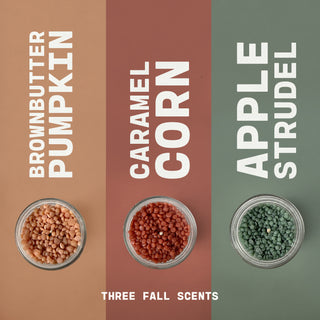 Three jars with scented wax beads labeled 'Brown Butter Pumpkin', 'Caramel Corn', and 'Apple Strudel' on a brown, red, and green background