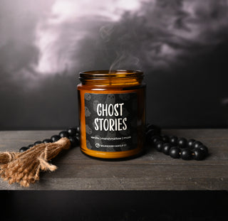 Candle labeled 'Ghost Stories' with smoke and decorative elements on a dark background