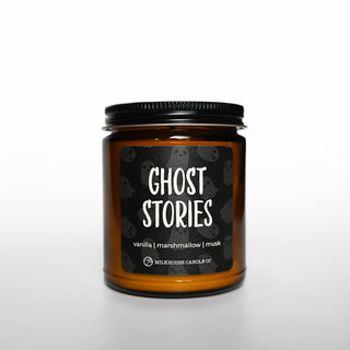 Candle jar labeled 'Ghost Stories' with a black lid on a white background