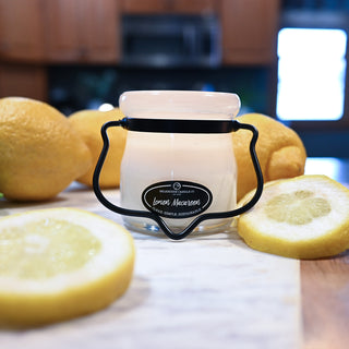 Jar candle with lemons on a wooden surface