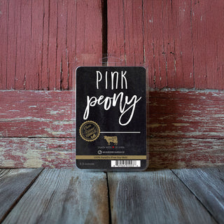 Pink Peony labeled wax melts on a wooden surface