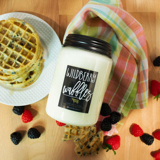 Jar of Wildberry Waffles candle with waffles and berries on a wooden surface