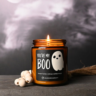 Candle with a ghost label on a dark background