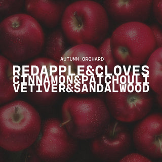 Red apples with text overlay of Autumn Orchard on a dark background with scent notes of red apple & cloves, cinnamon & patchouli and vetiver & sandalwood