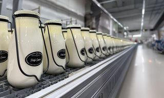 Row of fresh poured candles on a metal production line