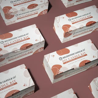 Milhouse Candle Co. DIY Candle Kit boxes on a dark rose colored background