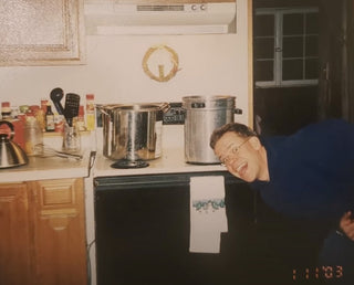 Eric making candles in their home kitchen 