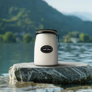 22 oz candle labeled 'North Shore' sitting on a rock in water