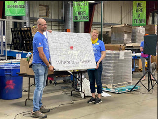 Eric and Janet holding a map of where their candle journey began