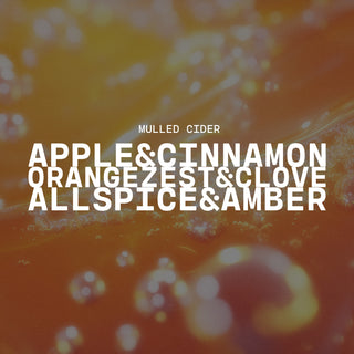 Text overlay on a orange and yellow blurred background with product name of Mulled Cider and description of apple & cinnamon, orange zest & clove and all spice & amber