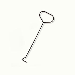 Black metal wick dipper on a white background