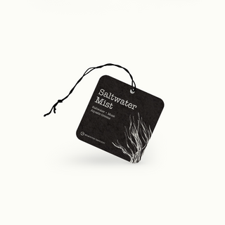 Black air freshener tag with 'Saltwater Mist' text and seaweed design on a white background