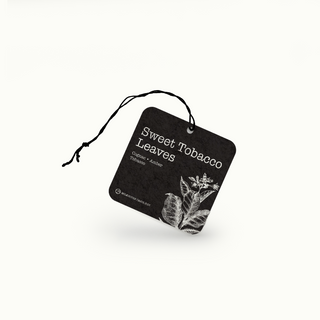 Sweet Tobacco Leaves air freshener with black and white design on a white background