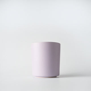 A lavender colored ceramic container against a white background