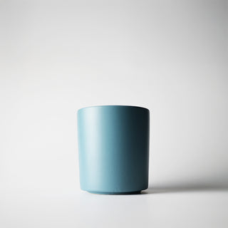 A dusty blue container against a white background