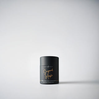A petite black  candle holder with the text 'Sugared Maple' written in gold, displayed against a white background