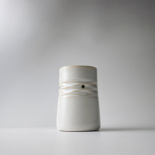 A white ceramic lattice melter against a white background