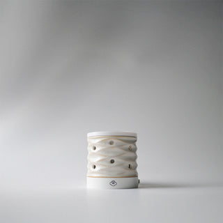 A white lattice wall plug in melter against a white background