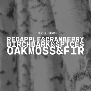 Silver Birch with a text overlay on a birch wood background with a product description of red apple & cranberry, birch bark & spices and oak moss & fir