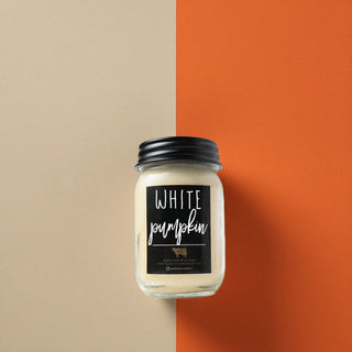 Candle jar labeled 'White Pumpkin' on a beige and orange background