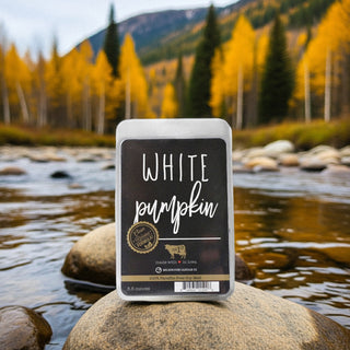 Packaged wax melts labeled 'White Pumpkin' with a scenic background of a river and trees
