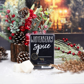 Winterberry Spice wax melt package with Christmas decorations in the background